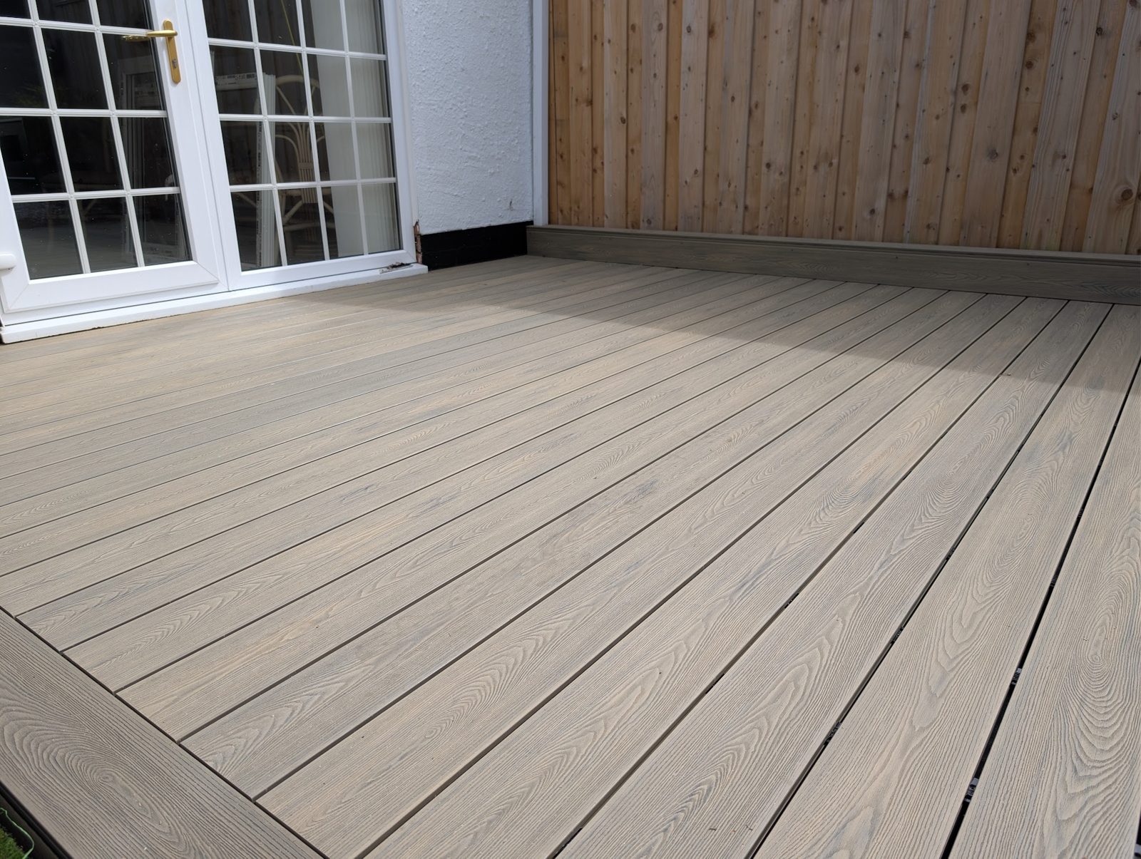 New composite decking outside a set of French doors